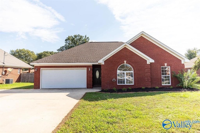 single story home featuring a front yard and a garage