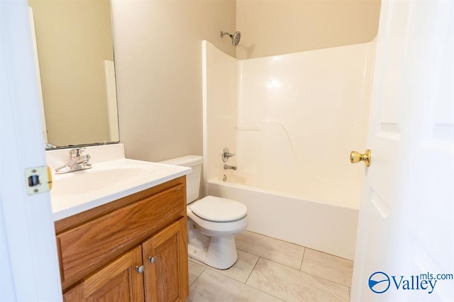 full bathroom with washtub / shower combination, tile patterned flooring, vanity, and toilet