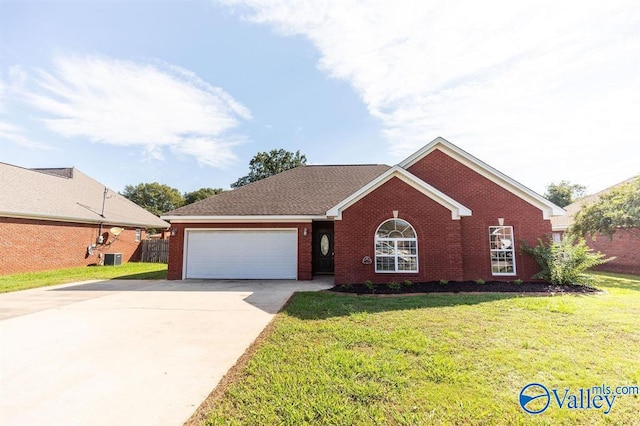 view of front of home with a front yard and a garage