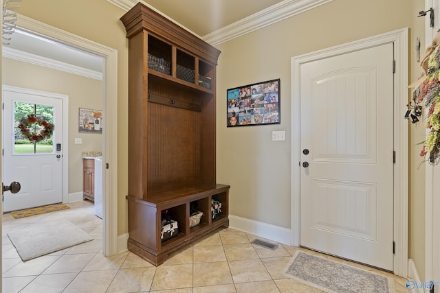 mudroom featuring crown molding, baseboards, and light tile patterned floors