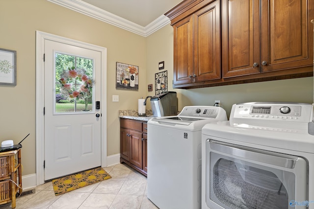 clothes washing area featuring ornamental molding, light tile patterned flooring, baseboards, separate washer and dryer, and cabinet space
