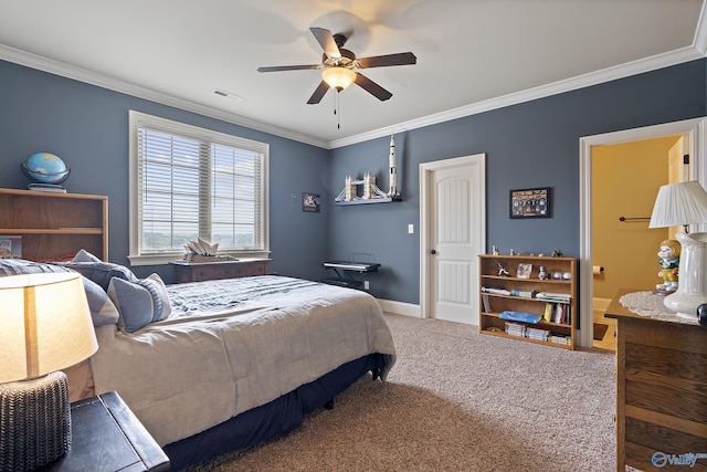 carpeted bedroom featuring crown molding, a ceiling fan, visible vents, and ensuite bath