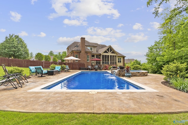 view of pool with fence, a hot tub, a fenced in pool, an outdoor living space, and a patio area