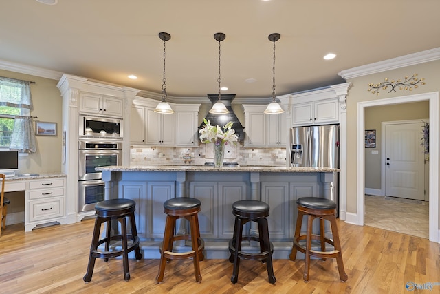 kitchen with crown molding, a center island, stainless steel appliances, white cabinetry, and decorative backsplash