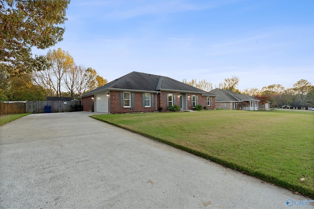 ranch-style home with a front lawn and a garage