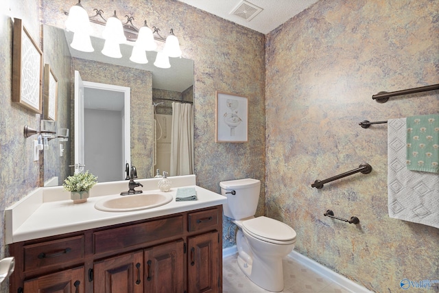 bathroom featuring vanity, toilet, and curtained shower