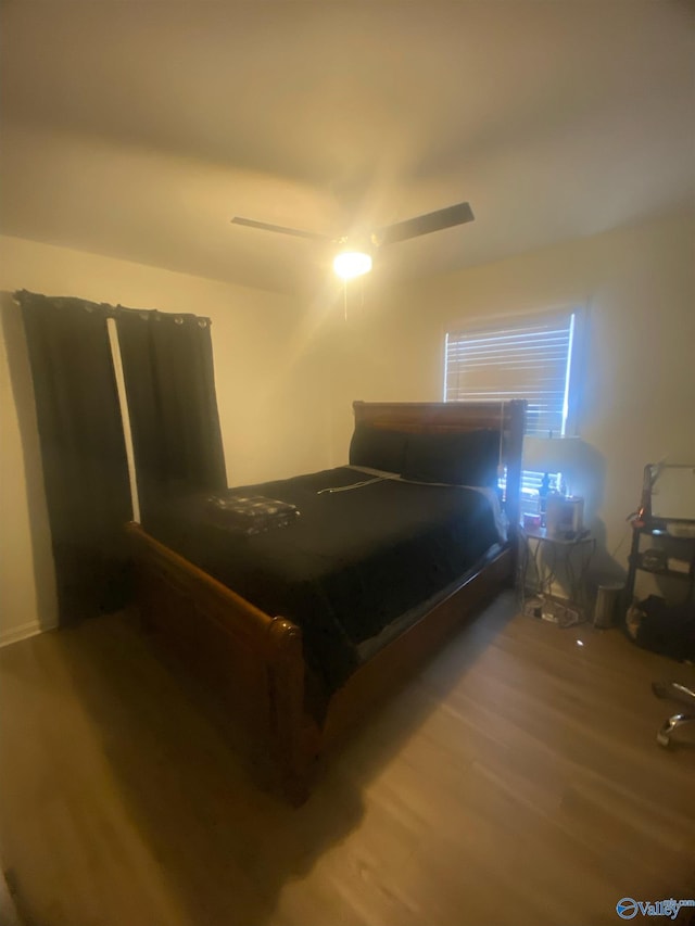 bedroom with ceiling fan and wood finished floors