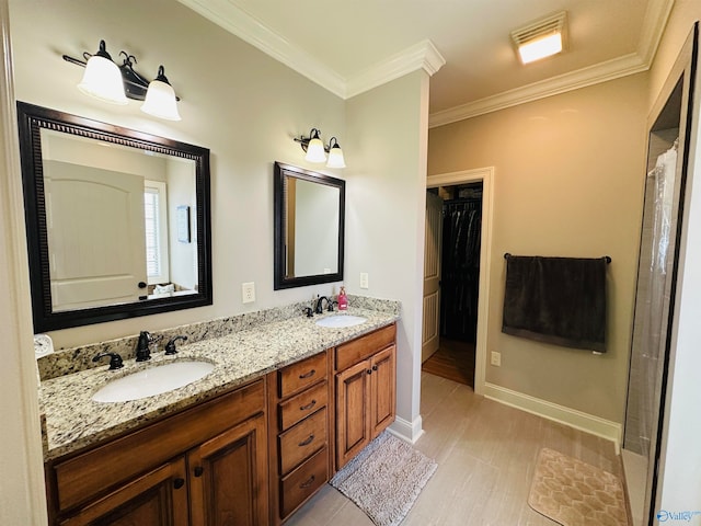 bathroom featuring hardwood / wood-style floors, vanity, and ornamental molding