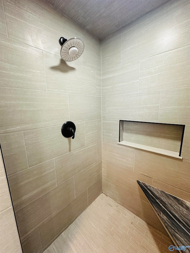 bathroom with tiled shower