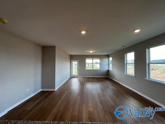 unfurnished room featuring dark hardwood / wood-style flooring