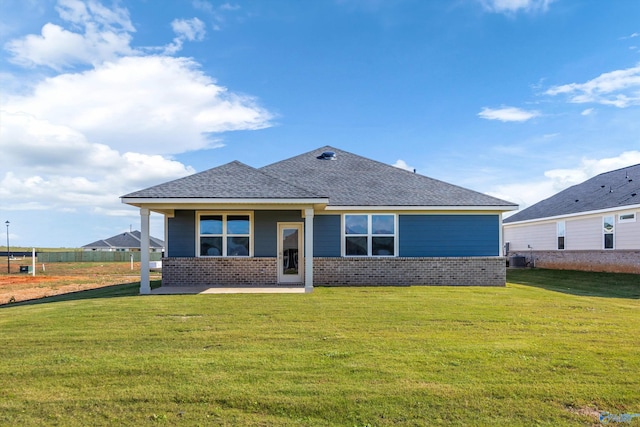 view of front of home with a patio area and a front yard