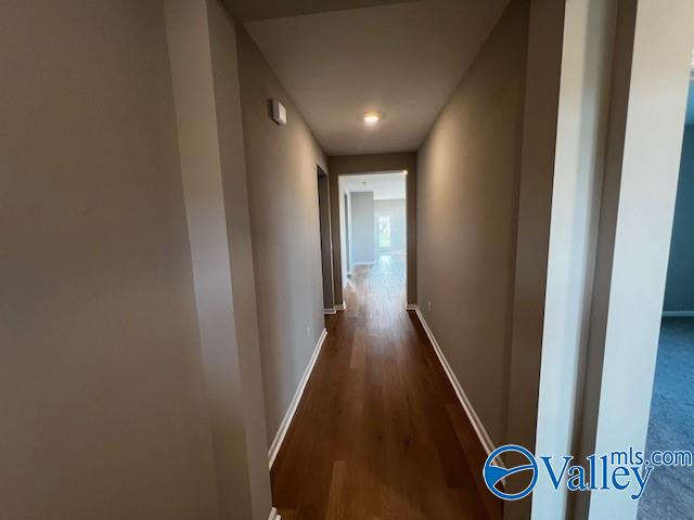 hallway with dark hardwood / wood-style floors