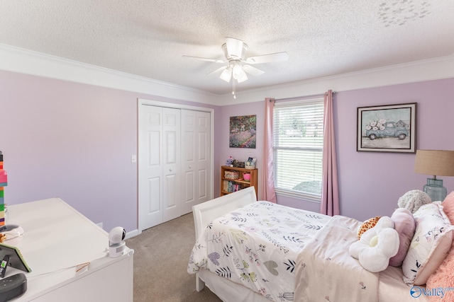 carpeted bedroom with ceiling fan, ornamental molding, a textured ceiling, and a closet