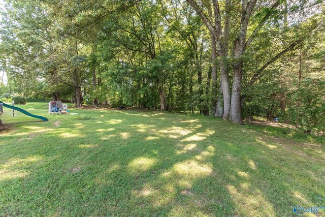 rear view of property with a yard and a deck