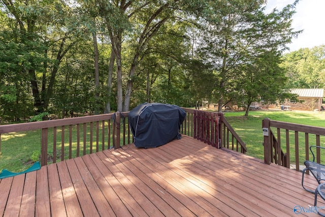 deck with area for grilling and a yard