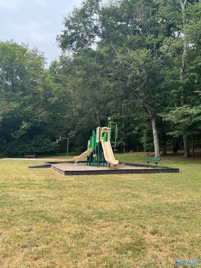 view of playground with a lawn