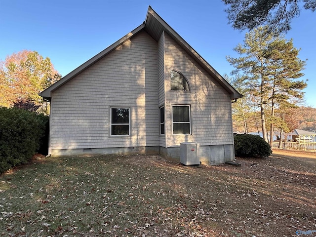 view of side of home featuring cooling unit