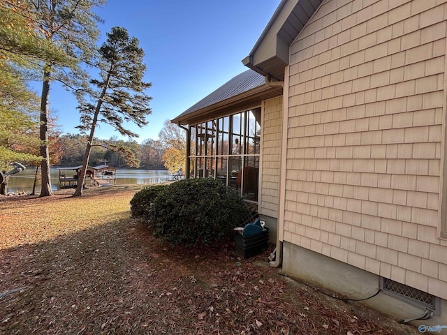 view of side of home with a water view