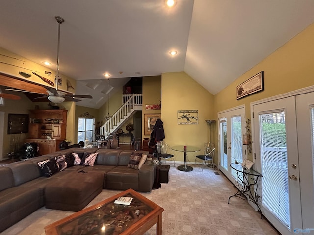 living room with ceiling fan, light carpet, high vaulted ceiling, and french doors