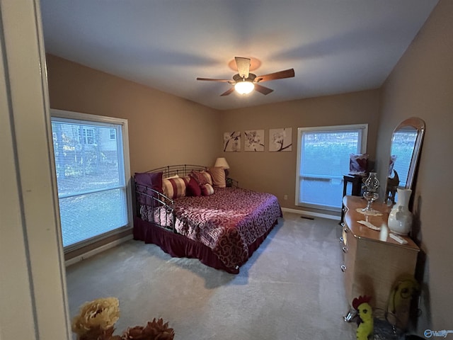 bedroom featuring light carpet and ceiling fan