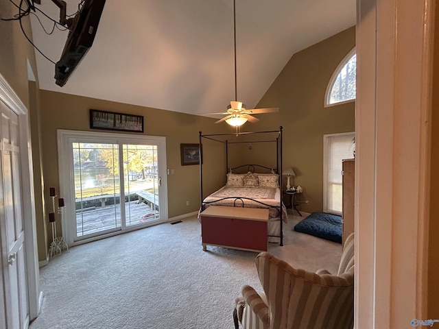 carpeted bedroom featuring multiple windows, ceiling fan, access to exterior, and high vaulted ceiling