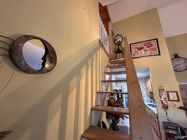 stairs featuring a towering ceiling