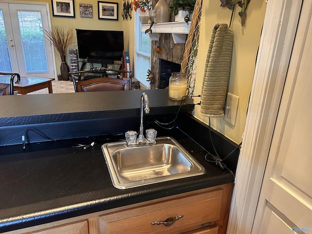 kitchen with sink and a stone fireplace