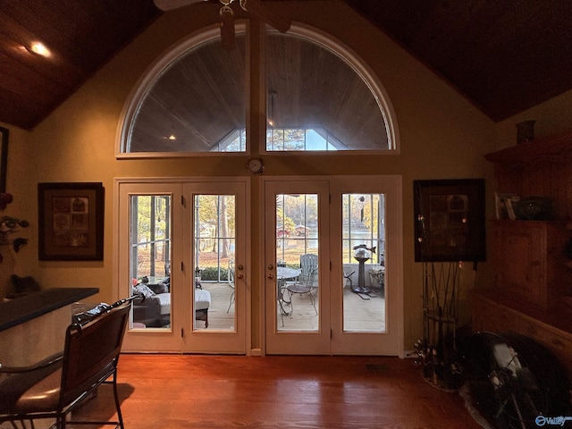 doorway to outside featuring lofted ceiling and wood-type flooring