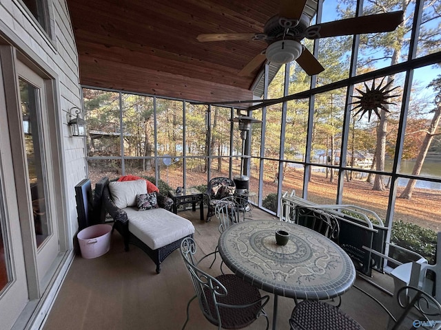 sunroom featuring wood ceiling, vaulted ceiling, and ceiling fan