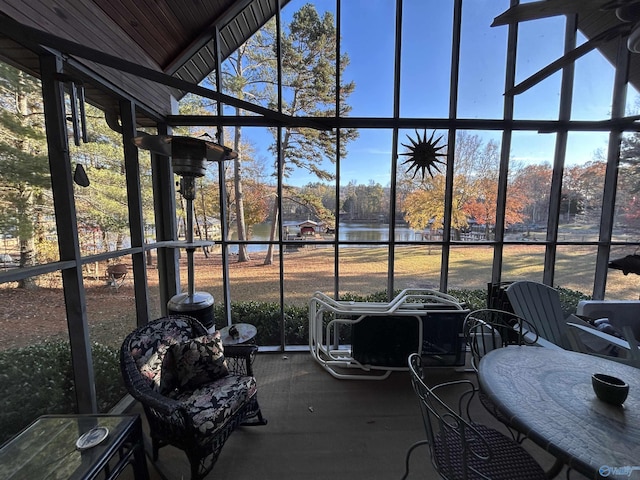 unfurnished sunroom with a water view