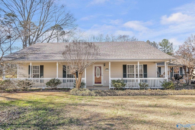 ranch-style home with a front lawn, a porch, and roof with shingles