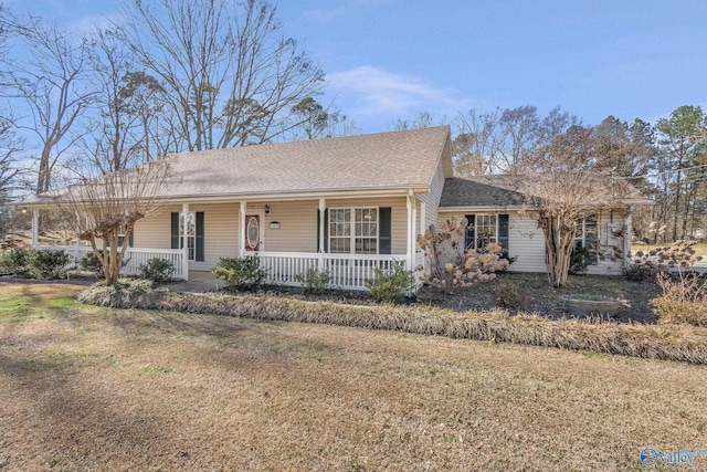 ranch-style house with roof with shingles, a porch, and a front lawn