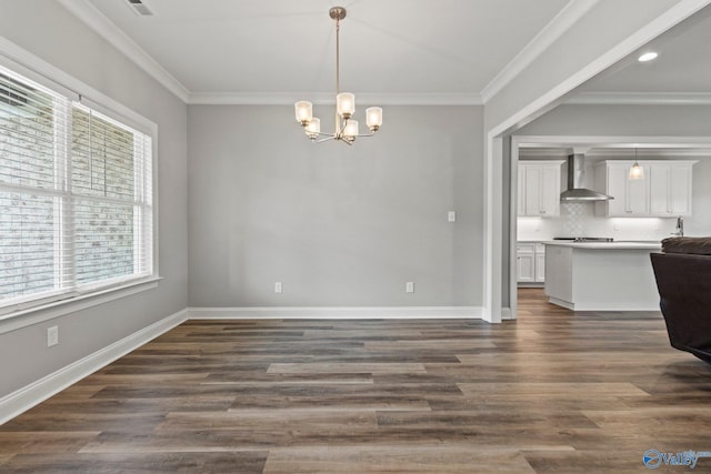 unfurnished dining area with a chandelier, crown molding, dark wood finished floors, and baseboards
