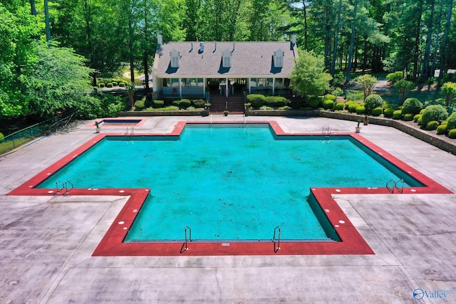 swimming pool with an in-ground hot tub and a patio