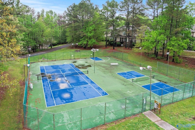 view of tennis court with view of scattered trees