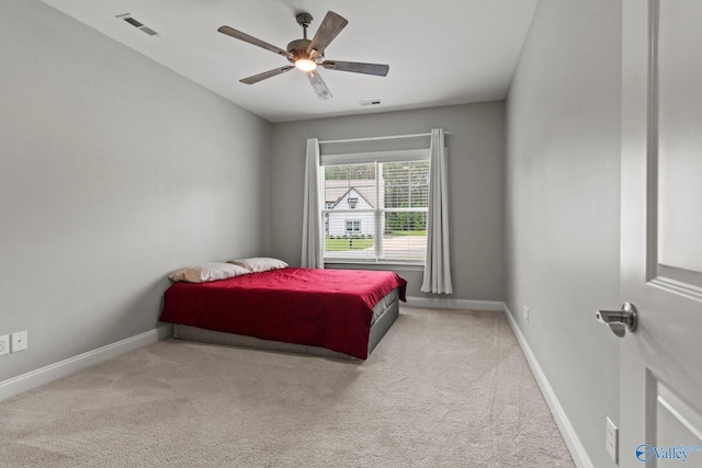 carpeted bedroom featuring baseboards and ceiling fan