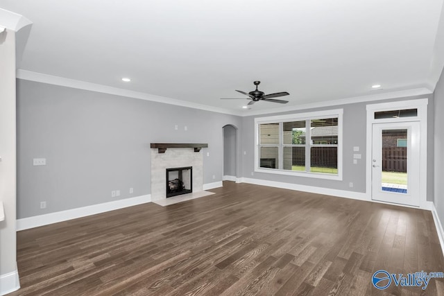 unfurnished living room with ornamental molding, dark hardwood / wood-style floors, and ceiling fan