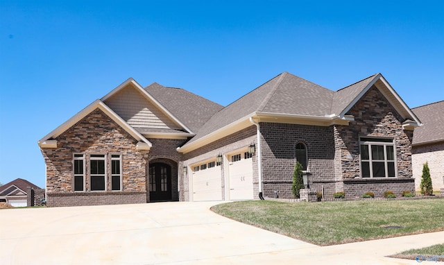 craftsman-style house with a garage and a front lawn