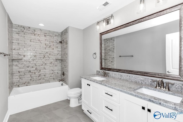 full bathroom featuring vanity, tiled shower / bath combo, and toilet