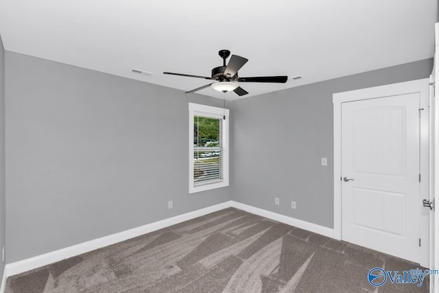 carpeted spare room with ceiling fan