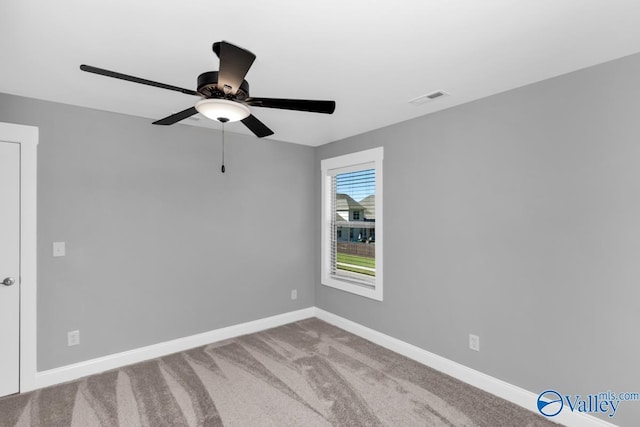 spare room featuring ceiling fan and carpet flooring