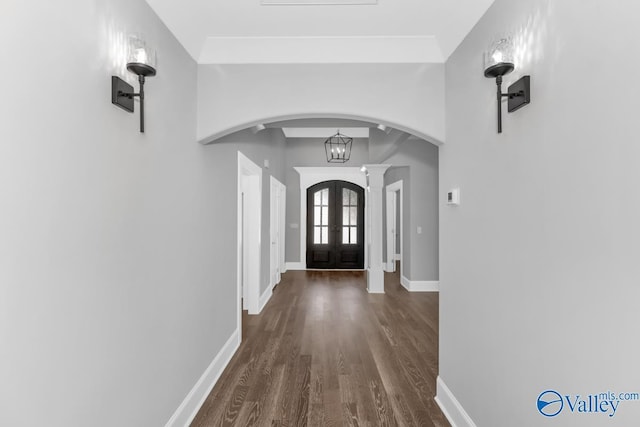 foyer entrance with dark hardwood / wood-style floors and french doors