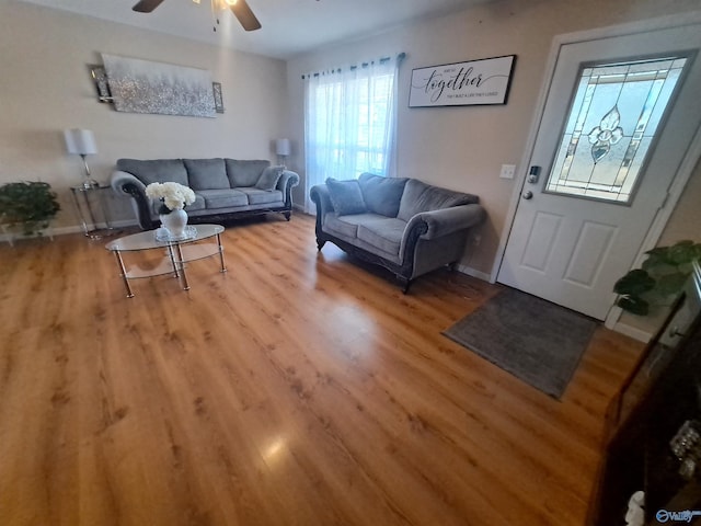 living room featuring hardwood / wood-style floors and ceiling fan