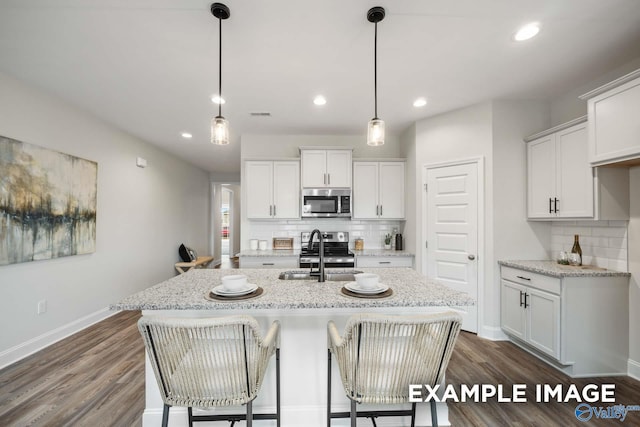 2652 Ajs Arbor Dr NW, Huntsville, AL 35810 - kitchen with white cabinets, a sink, backsplash, and appliances with stainless steel finishes