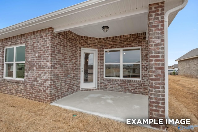 2652 Ajs Arbor Dr NW, Huntsville, AL 35810 - view of exterior entry with brick siding and a patio