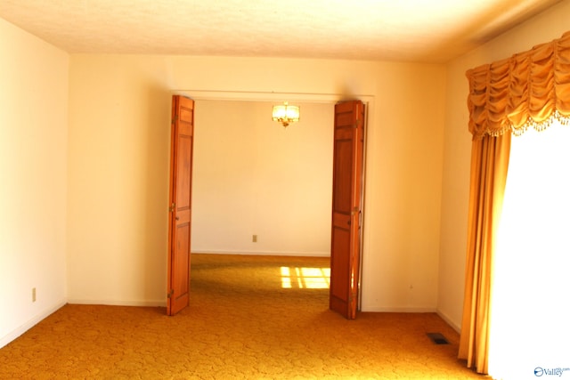 spare room with light colored carpet