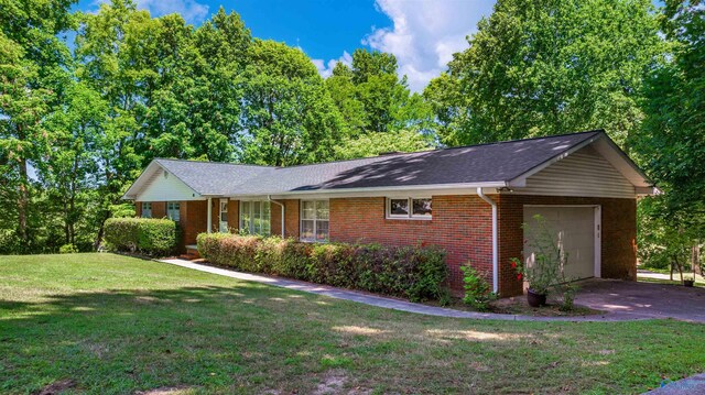 ranch-style home with a front yard, a garage, and covered porch