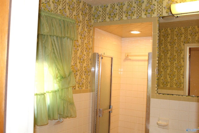 bathroom with tile walls and walk in shower