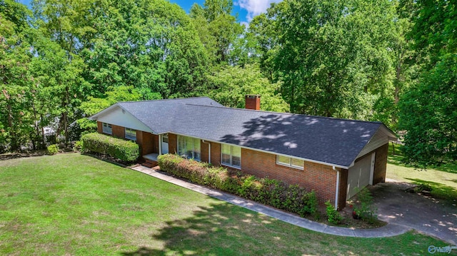 ranch-style home with a front yard and a garage