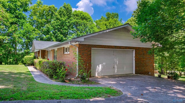 view of property exterior featuring a garage and a yard